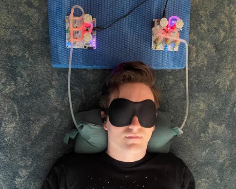 Myself using the 3rd iteration of the Neck Hammock while wearing an eye mask and ear buds.