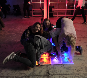 Playing twister on an interactive light-up floor which I developed.